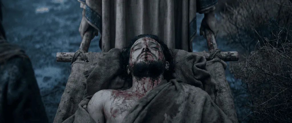 A wounded man carried on a wooden stretcher